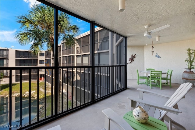 1401 Middle Gulf Dr Unit 301N, Sanibel, FL 33957 - balcony with ceiling fan and outdoor dining space