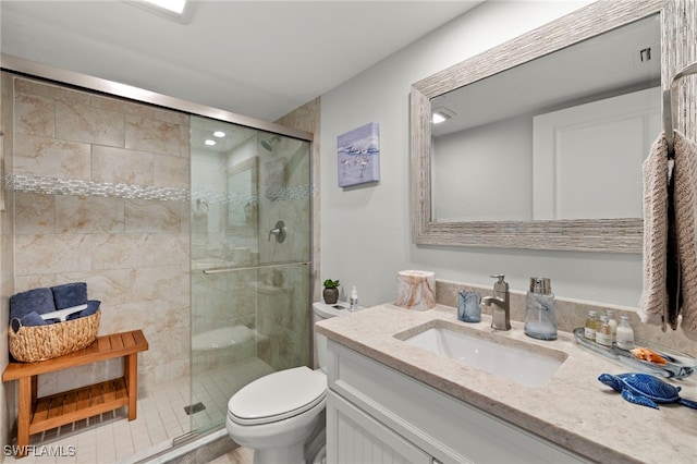 bathroom with a shower with door, toilet, and vanity