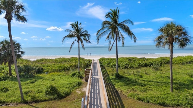 view of home's community with a beach view and a water view