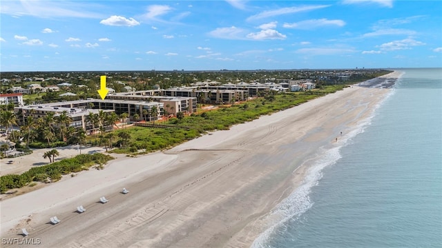 bird's eye view featuring a water view and a beach view