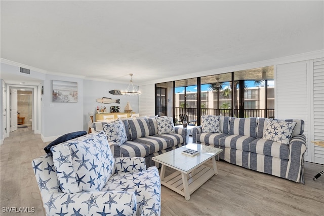 1401 Middle Gulf Dr Unit 301N, Sanibel, FL 33957 - living room with light wood-type flooring, ornamental molding, baseboards, a chandelier, and visible vents