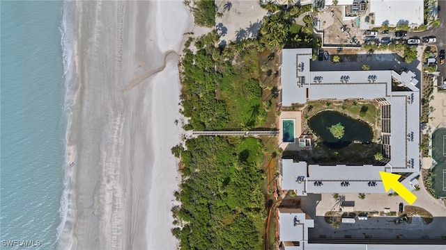 bird's eye view with a water view and a beach view