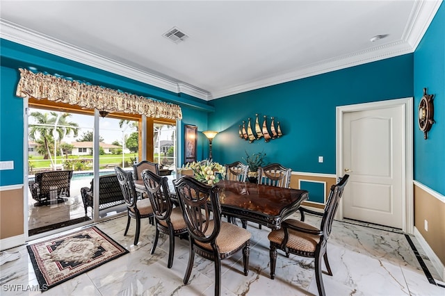 dining room featuring crown molding