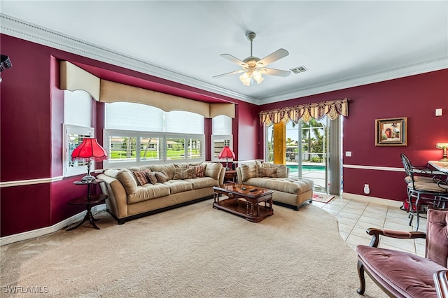 carpeted living room with crown molding and ceiling fan