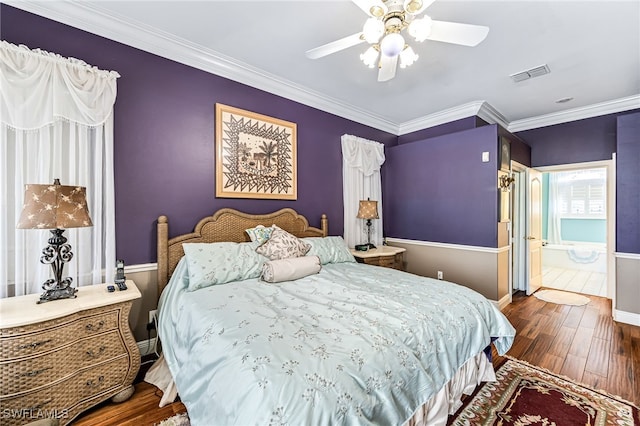 bedroom featuring ornamental molding, dark hardwood / wood-style floors, connected bathroom, and ceiling fan