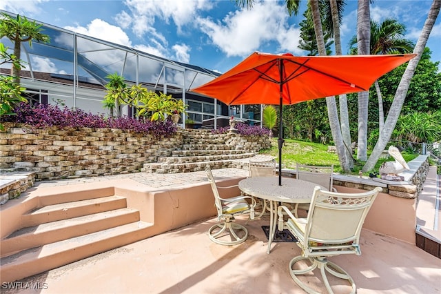 view of patio / terrace featuring a lanai