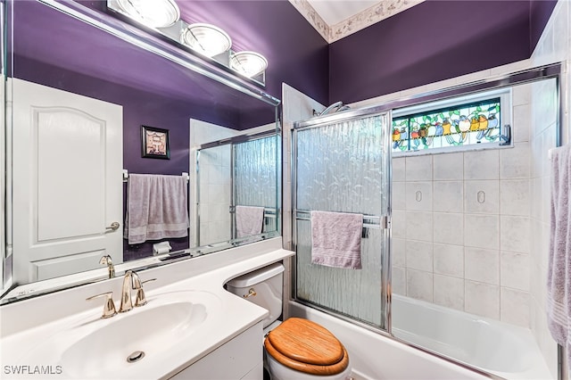 full bathroom with vanity, toilet, and shower / bath combination with glass door