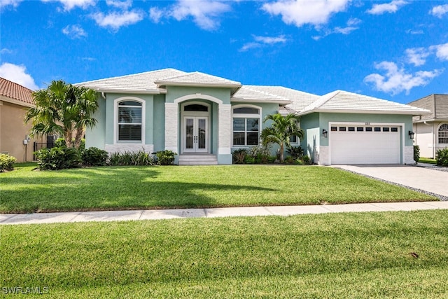 view of front of home featuring a garage and a front yard