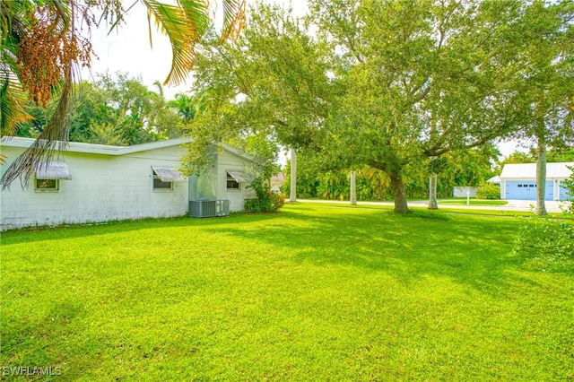 view of yard with a garage and cooling unit