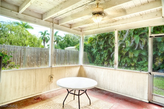 unfurnished sunroom featuring ceiling fan