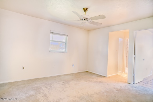 unfurnished room featuring ceiling fan and light carpet