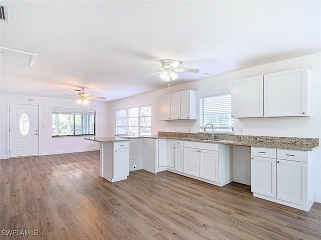 94 E N Shore Ave, North Fort Myers, FL 33917 - kitchen with a ceiling fan, a peninsula, and light wood-style flooring
