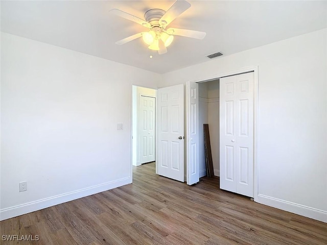 94 E N Shore Ave, North Fort Myers, FL 33917 - unfurnished bedroom featuring wood finished floors, a closet, and ceiling fan