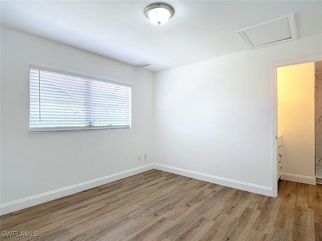 94 E N Shore Ave, North Fort Myers, FL 33917 - empty room with wood finished floors and attic access