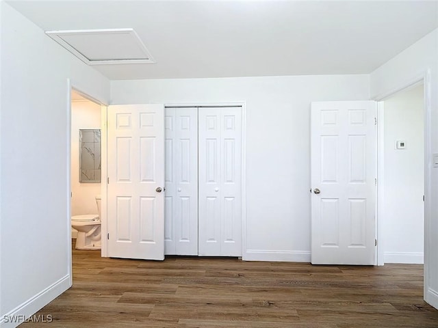 94 E N Shore Ave, North Fort Myers, FL 33917 - unfurnished bedroom with wood finished floors, attic access, and a closet