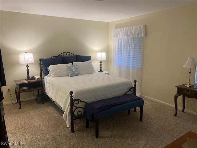 carpeted bedroom featuring baseboards