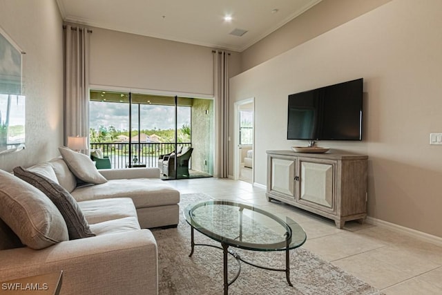 living area featuring crown molding, baseboards, a wealth of natural light, and light tile patterned floors