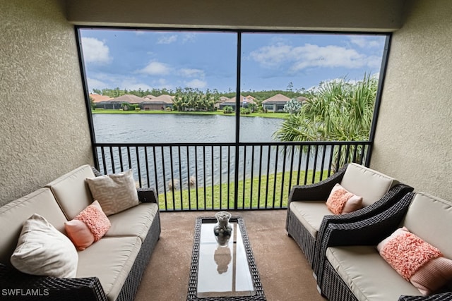 sunroom featuring a water view