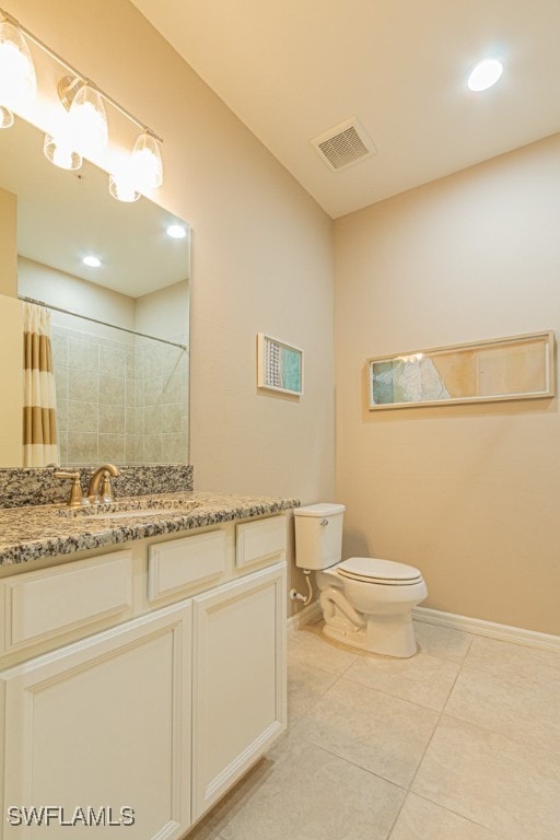 bathroom featuring tile patterned floors, vanity, and toilet