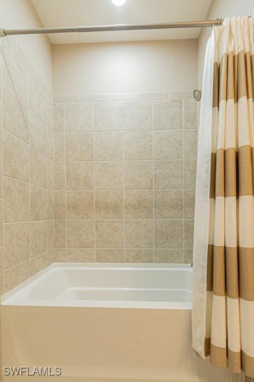 bathroom with shower / bathtub combination with curtain