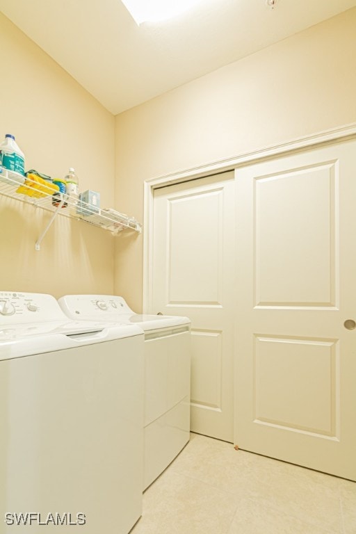 laundry area with light tile patterned flooring and independent washer and dryer