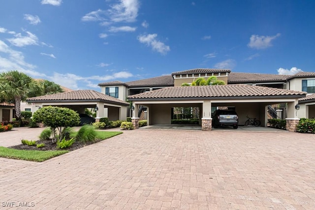 view of front of home featuring a tiled roof and stucco siding