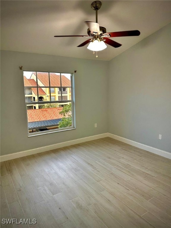 spare room featuring ceiling fan and light hardwood / wood-style flooring