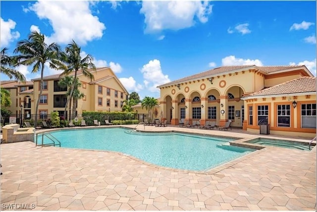 view of pool featuring a patio area and a hot tub