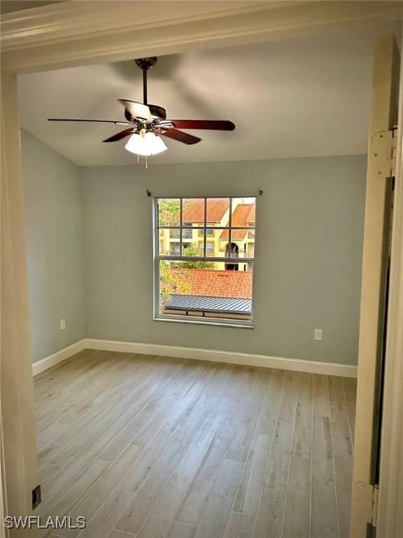 empty room featuring ceiling fan and light hardwood / wood-style flooring