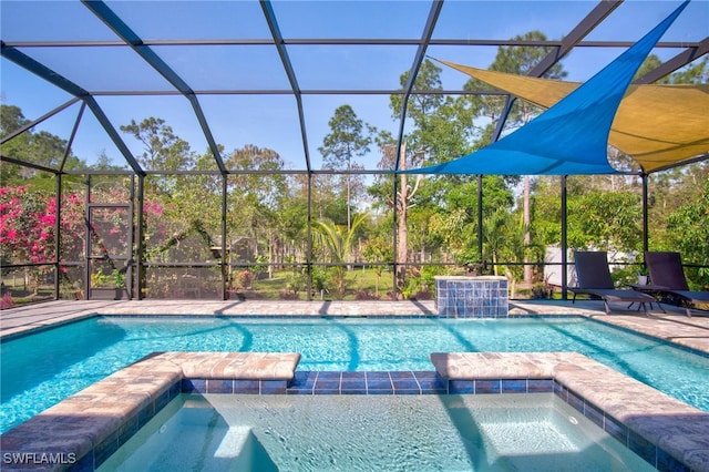 view of swimming pool with pool water feature, an in ground hot tub, and glass enclosure