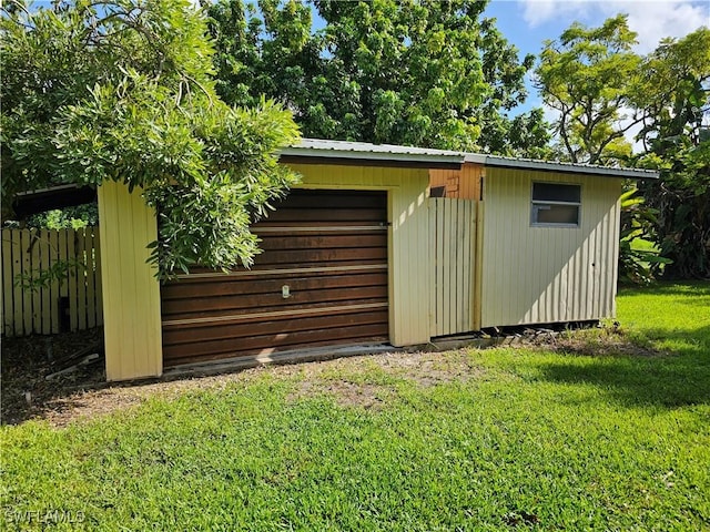 view of outbuilding featuring a lawn