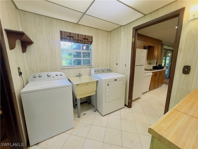 laundry room with light tile patterned floors and wood walls