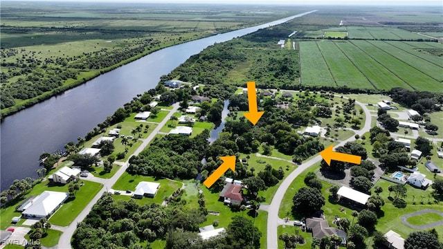 birds eye view of property with a rural view and a water view