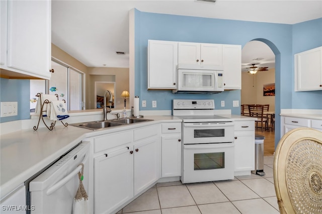 kitchen with white appliances, light tile patterned floors, sink, white cabinetry, and ceiling fan