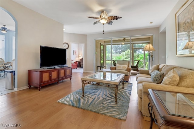 living room featuring light hardwood / wood-style flooring and ceiling fan