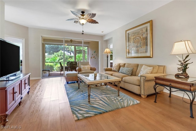 living room with ceiling fan and hardwood / wood-style flooring