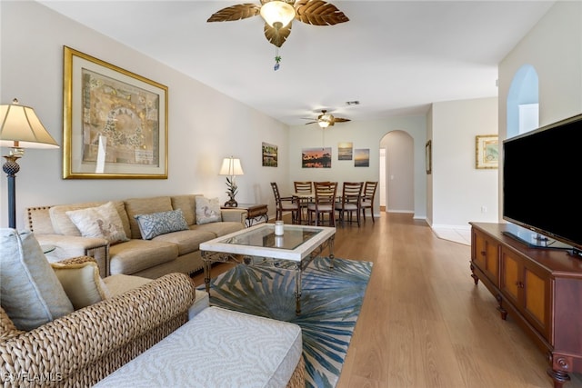 living room with hardwood / wood-style floors and ceiling fan