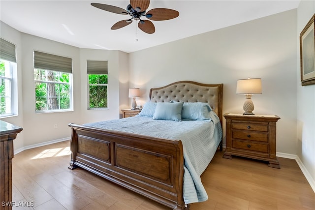 bedroom with ceiling fan and light hardwood / wood-style floors