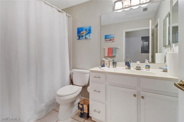 bathroom with vanity, toilet, and tile patterned flooring