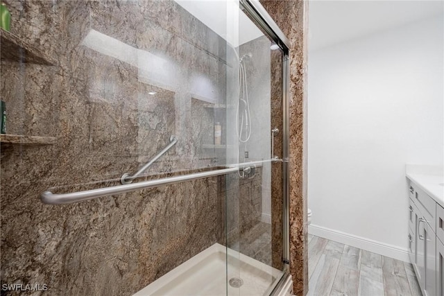 bathroom featuring vanity, toilet, and an enclosed shower