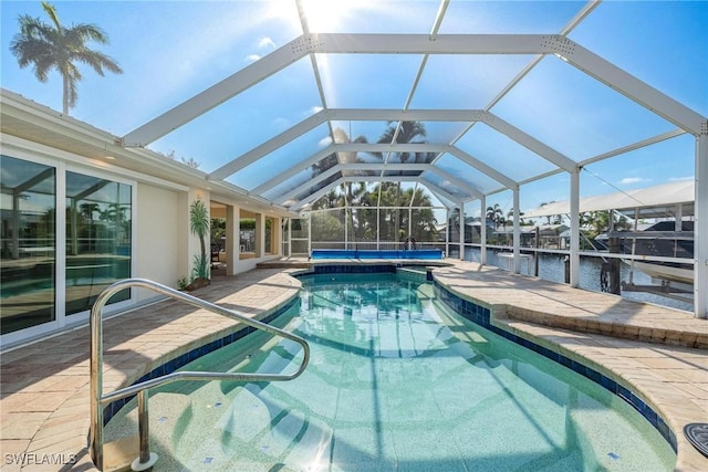 view of pool with a boat dock, a water view, glass enclosure, and a patio area