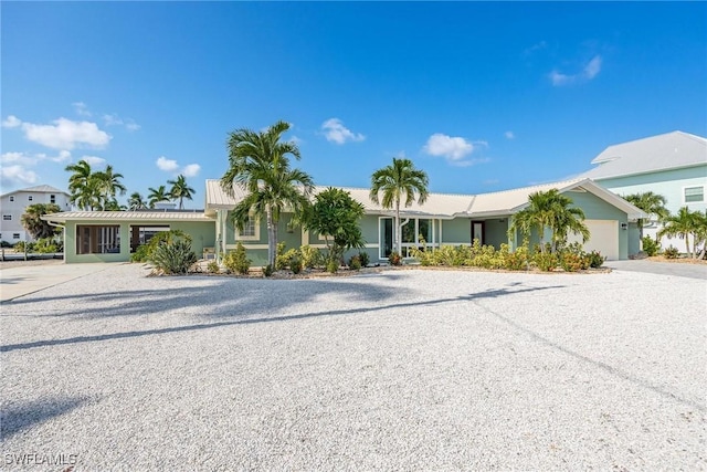 ranch-style home with an attached garage and driveway