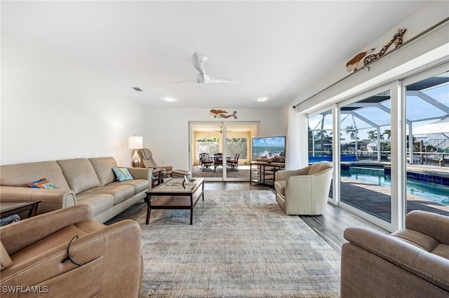 living room featuring ceiling fan and light hardwood / wood-style floors