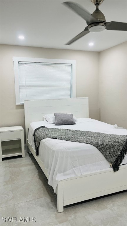 bedroom with light tile patterned flooring, ceiling fan, and multiple windows