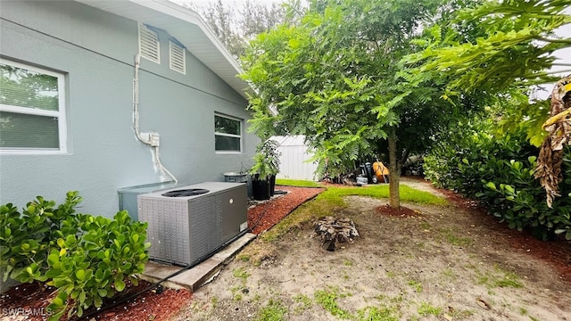 view of yard featuring central air condition unit