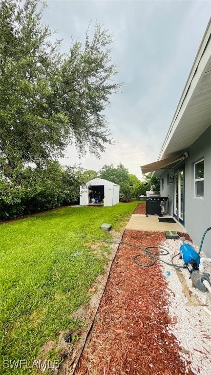 view of yard with an outdoor structure and a patio