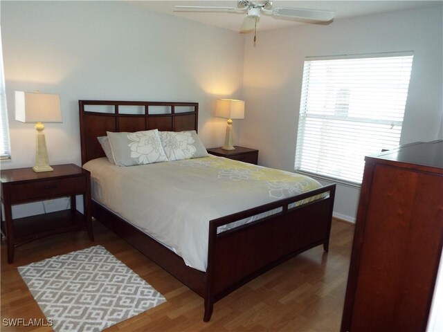 bedroom with ceiling fan and dark hardwood / wood-style floors