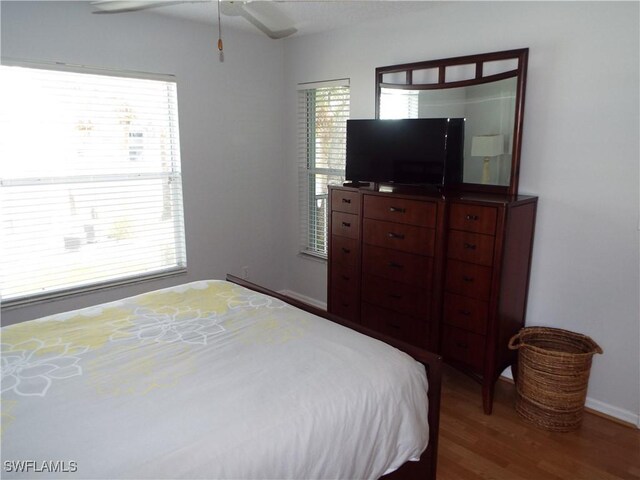 bedroom with hardwood / wood-style floors and ceiling fan