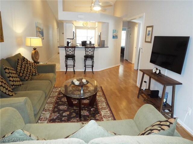 living room featuring ceiling fan and hardwood / wood-style floors