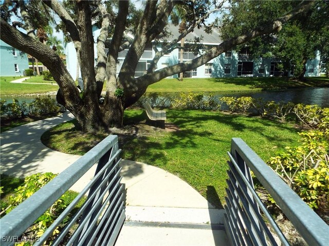 view of home's community featuring a water view and a yard